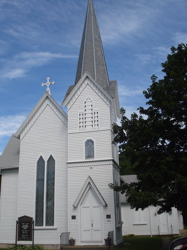 White Episcopal church building with steeple